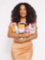 A Hispanic woman smiling while holding her hair products