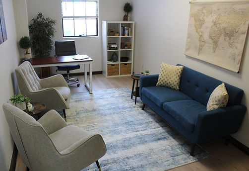 Assessment office with a couch, chairs, and a desk.