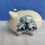 Thumbnail: side of a large delft blue handpainted piggy savings bank with flowers and a windmill decoration beautiful gift from Holland