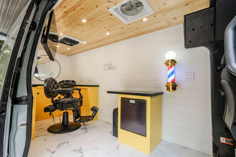 Full custom mobile barbershop with cool light accessories and salon chair for clients