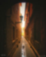 Water fountain with artistic broze faces in narrow street in Ljubljana, Slovenia