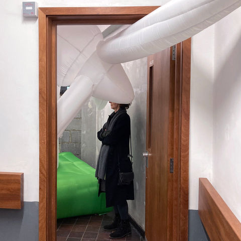 inflated windmill pokes out door of gallery because it doesn't fit.
