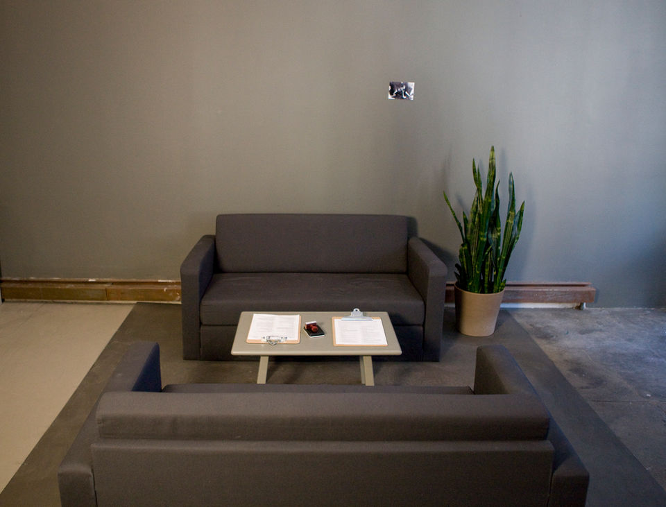 living room where guests can fill out intake form. video art. performance. social practice.