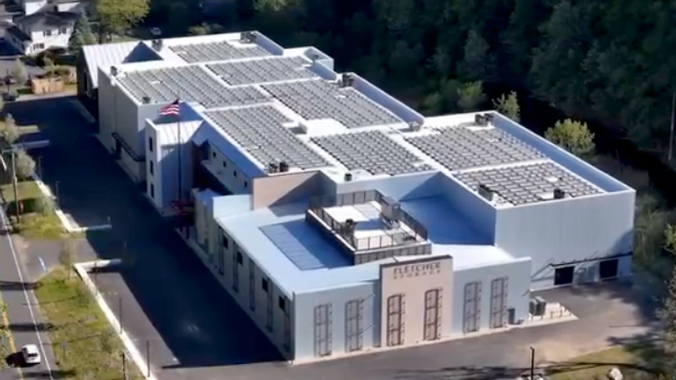 Aerial view of a modern high-end self-storage facility with rooftop solar panels in Redding, CT.