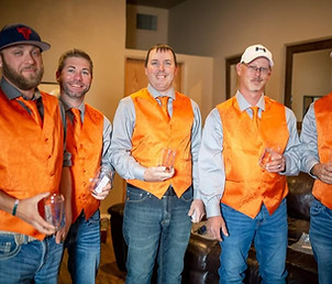 Groomsmen holding drinks and standing in Groom's Den