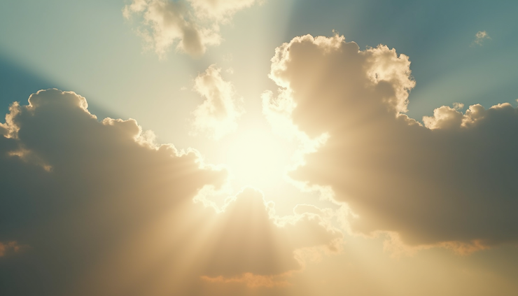 Close-up view of a partly cloudy sky with sun rays breaking through