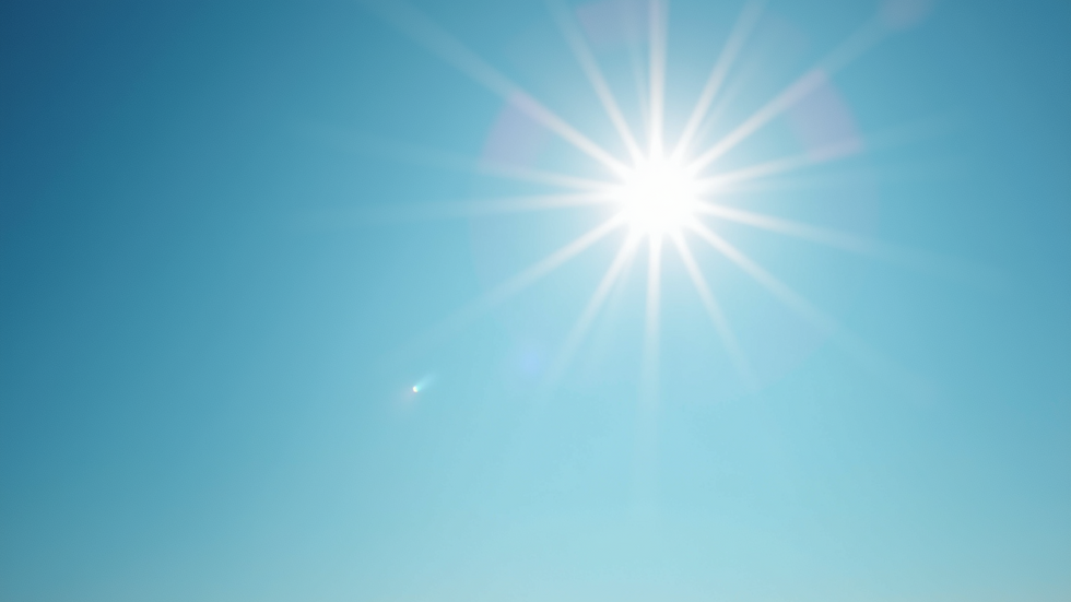 Eye-level view of clear blue skies with a vibrant sun