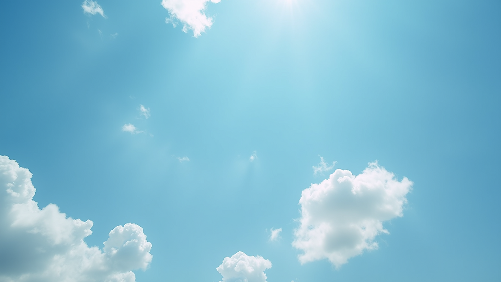 Eye-level view of a bright blue sky with a few fluffy white clouds