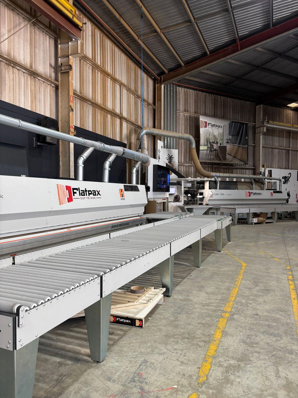 Two large edgebanders in cabinetry manufacturing factory