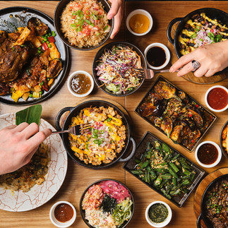 Kasa and Kin Filipino restaurant Soho London shared dining table with sisig, rice bowls, grilled meats, and side dishes