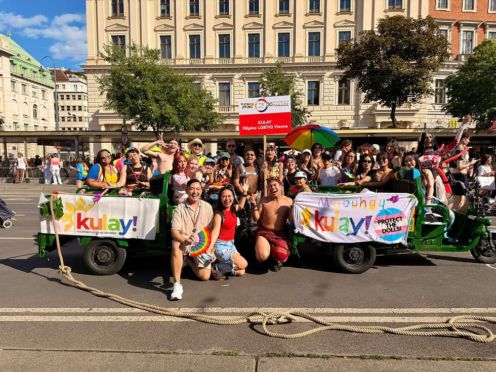 Chris Sta. Brigida-Kopp and fellow members of the Filipino LGBTQIA+ community gather with the Philippine flag overlooking Vienna during a cultural celebration.