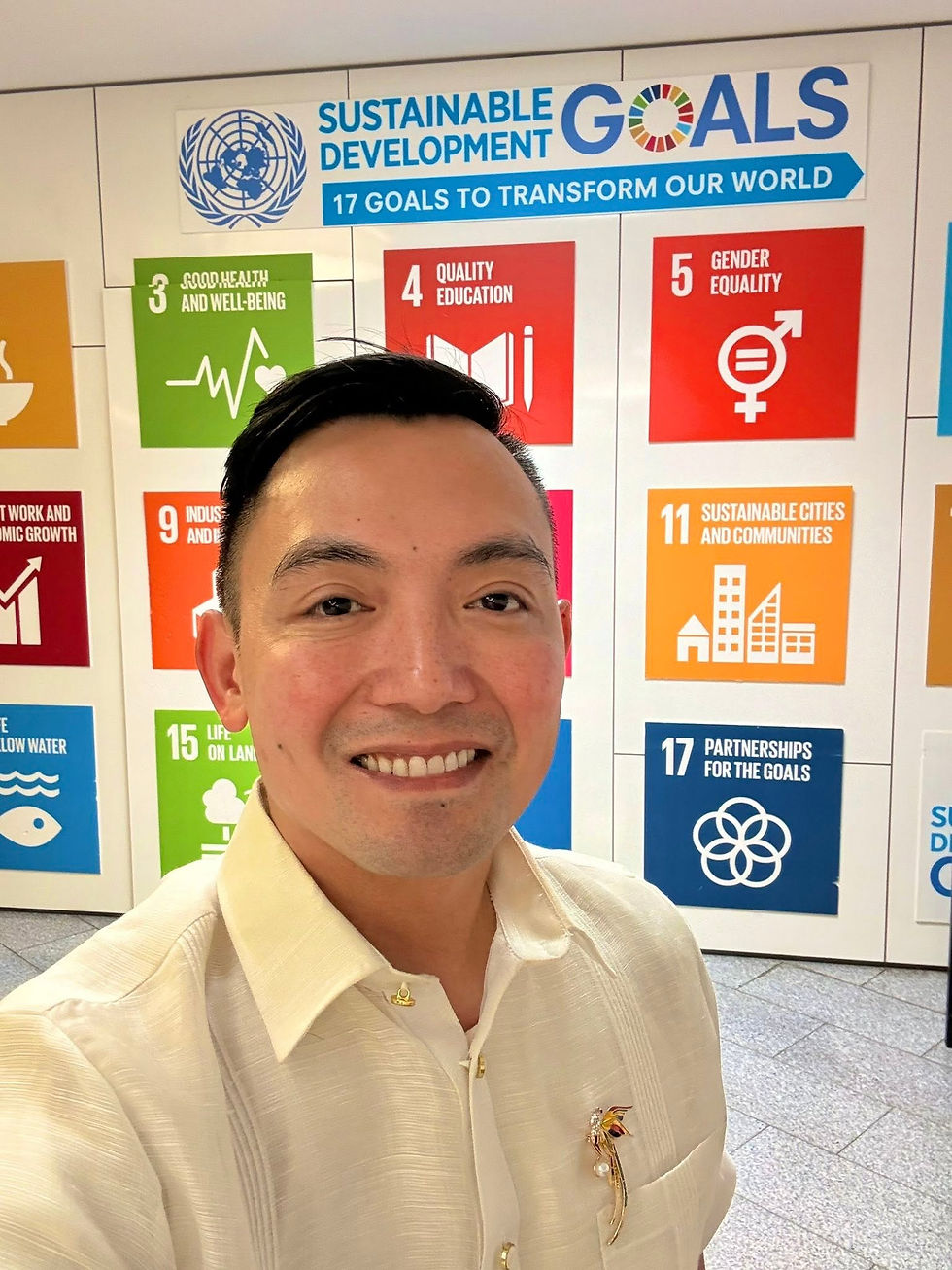 Chris Sta. Brigida-Kopp at the United Nations Sustainable Development Goals display, reflecting his advocacy for inclusion, equality, and Filipino LGBTQIA+ representation.
