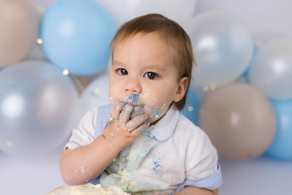 Baby boy eating cake