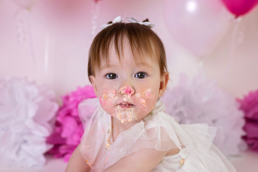 baby girl with icing on face