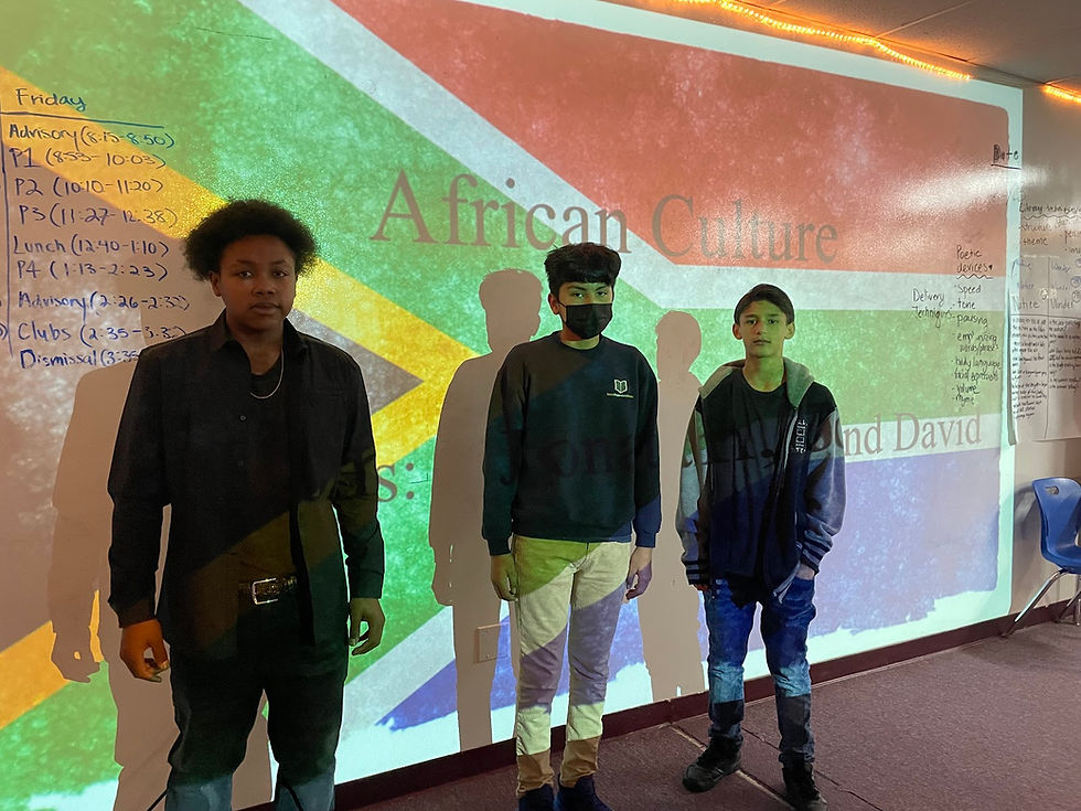 Students from Aurum Preparatory Academy poses in front of a project display board for Black History Month.