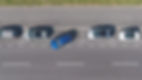 DRONE, TOP DOWN_ Flying above a shiny blue car driving out of a roadside parking space. Mo
