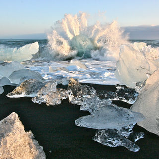 Photograph of a wave crashing on Jokulsarlon black sand beach