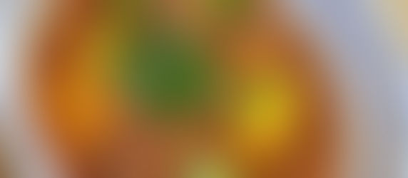 A version of wedding soup with chickpeas, pearl pasta, and spiced kofta in a seasoned tomato broth