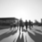 I want an image of people walking away as they are leaving a fitness class with the sun in