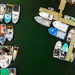 Go Visit Western Newfoundland - drone image or boats tied up at a dock