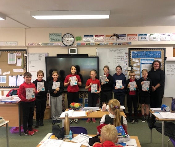 Belchamp St Paul School Y5 receiving their bible from Rev Gill