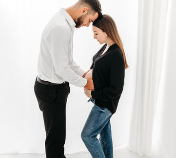 pregnancy photoshoot of a beautiful couple facing each other