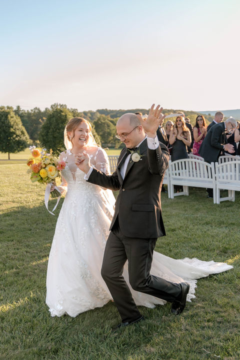 Luxary wedding at Lion Rock Farm in Sharon Connecticut. Married couple walking down the aisle after ceremony.