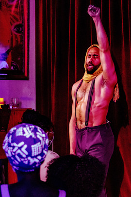Actor Nathan Nonhof raises his fist in a production photo from "Black Seance"