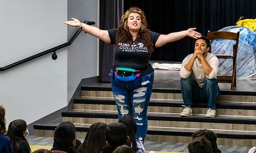 Producing Artist Shellina Hefner stands in front of a large group of students in a Blindspot Collective t-shirt during an interactive program