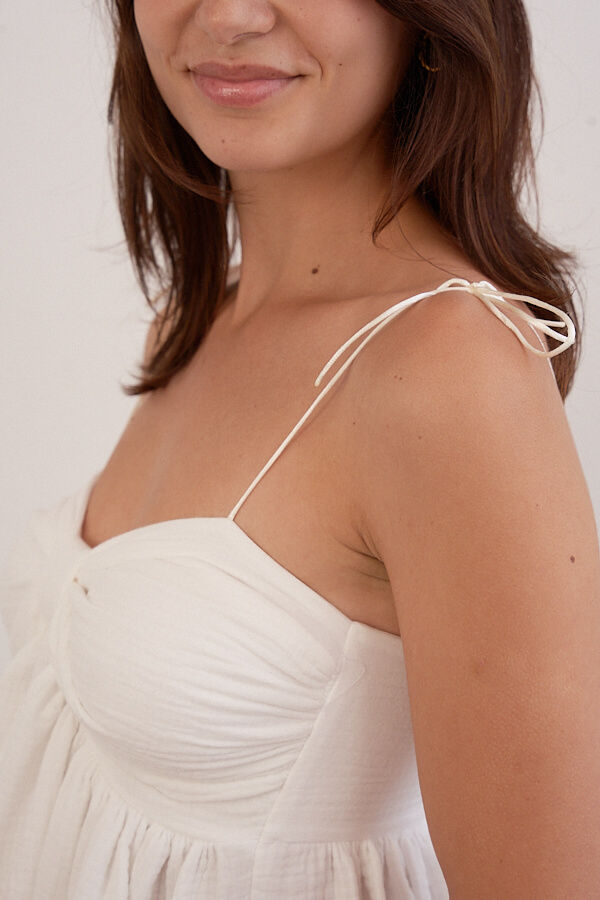 Thumbnail: Ellie Dress detail showing natural cotton fabric and artisan craftsmanship