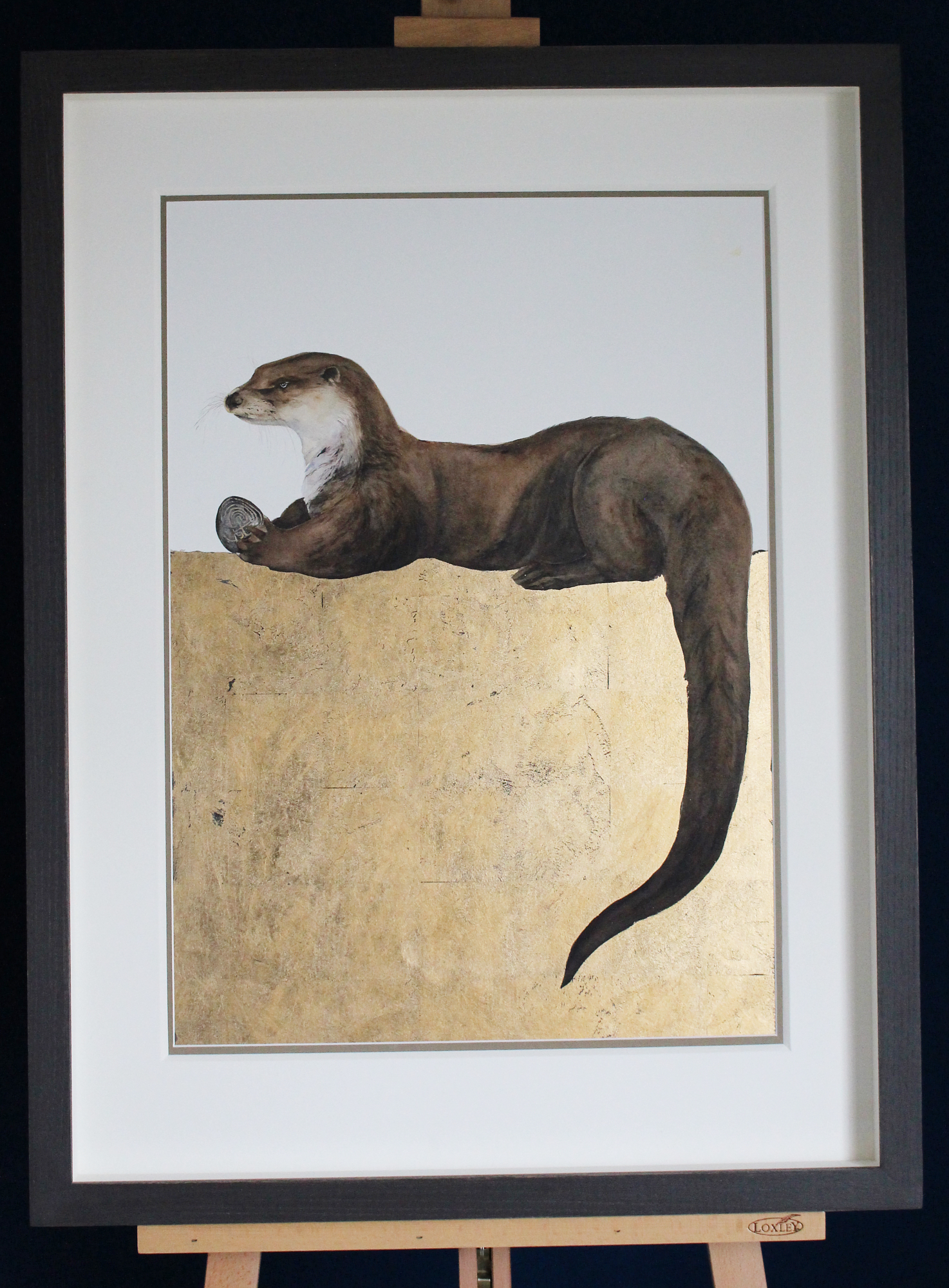 otter with labyrinth stone