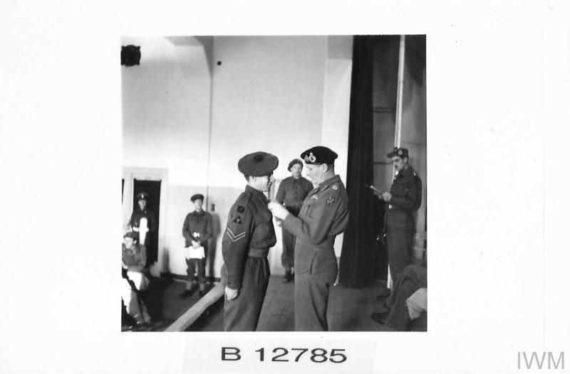 Corporal J. Forrest of 1 KOSB receives the Military Medal during the 3rd British Division investiture at Gimers Monastery, British Army, 21st Army Group.