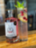 Raspberry mojito with raspberry gin, mint, lime and sparkling water served over ice