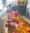 Raspberry lemonade cocktail with raspberry gin, lemon, mint and raspberries served over ice