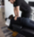 Chiropractor performing spinal adjustments on a patient