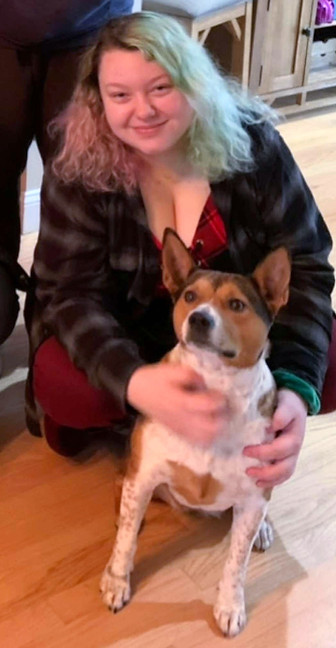 smiling woman petting a dog