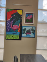 Paintings laid out for hanging.