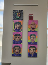 Paintings laid out for hanging.