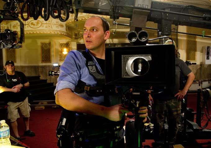 Louis Leterrier operating a film camera on set.