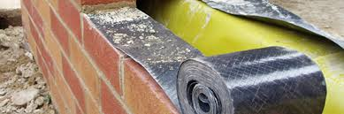 Damp proof membrane (DPM) being installed to form damp proof course (DPC)
