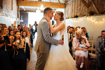 A bride and groom about to share their first kiss during their wedding at The Barn at Brookend Green Farm captured by Tara Gillen Photography