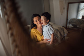 A creative photograph taken by Tara Gillen photography showing the reflection of a mother and her son in a mirror relaxing during their photoshoot