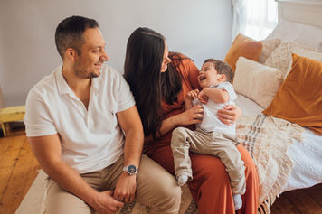 A family of three laughing as the mum tickles the son during their photoshoot with Tara Gillen Photography in Befordshire
