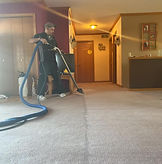 A tech cleaning carpet