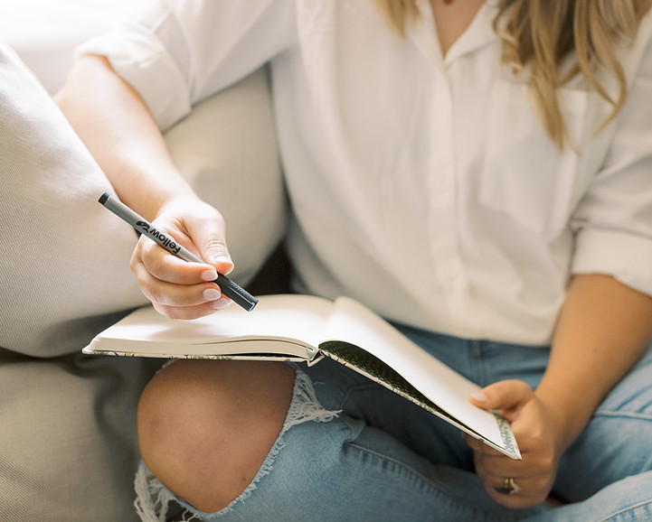 A therapist writing in a notebook