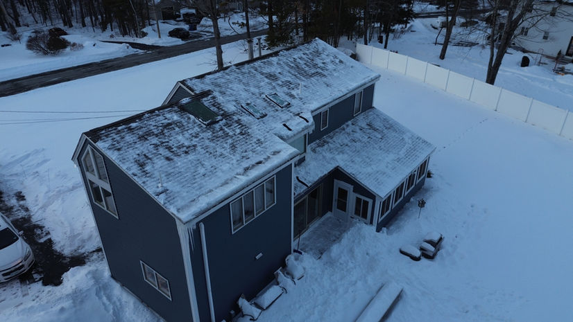Close-up of asphalt roof shingles during roof rake