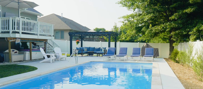 The River Pools D28 nestled into a small backyard in Howard, WI by Pool Pros