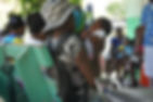 a baby smiling at its mum while they wait to see the nurse at Bethesda Medical Center, Haiti.