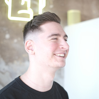 Mid skin fade, with the hair sweeping to the side, the fringe is longer then the rest