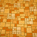 An old, orange linoleum floor, probably from the 1970s, in a brick-like pattern